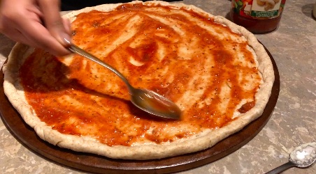pizza sauce on the pizza crust