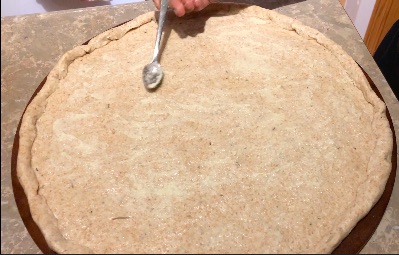 pizza crust and adding toppings